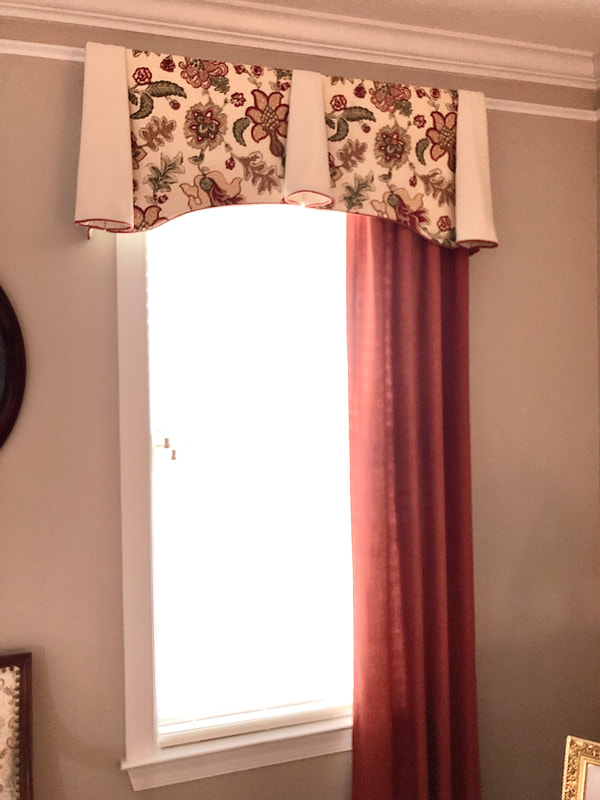arched cornice valance with floral curtain drapery in living room